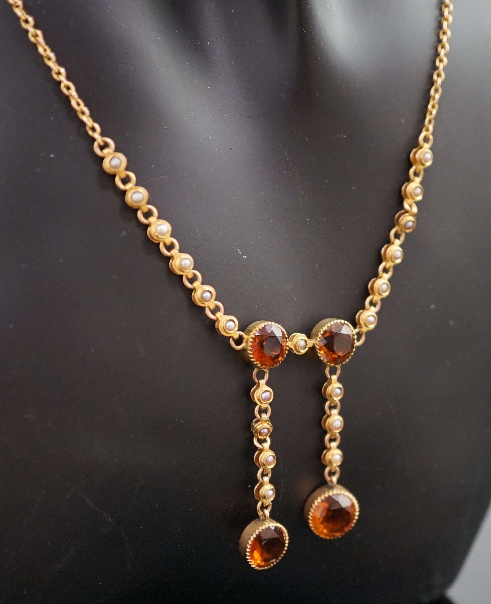 An Edwardian 15ct gold, seed pearl and citrine graduated double drop necklace